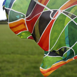 A green and red silk scarf floating in the wind